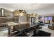 Stylish kitchen featuring stainless steel appliances, modern pendant lighting, and breakfast bar seating at 4381 W Flamingo Rd # 57306, Las Vegas, NV 89103