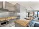 Stainless steel kitchen featuring modern appliances, granite countertops, and open living area at 4381 W Flamingo Rd # 57306, Las Vegas, NV 89103