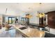 Bright kitchen island with breakfast bar seating and an open view of the city and living area at 4381 W Flamingo Rd # 57306, Las Vegas, NV 89103