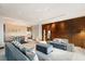 Open-concept living room featuring wood-paneled accent wall, modern furnishings, and recessed lighting at 4381 W Flamingo Rd # 57306, Las Vegas, NV 89103