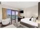 Bright bedroom featuring floor-to-ceiling windows, a soaking tub, and cityscape views, offering a luxurious urban retreat at 4381 W Flamingo Rd # 57306, Las Vegas, NV 89103