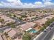 Aerial view of a residential neighborhood featuring single-Gathering homes, pools, and manicured lawns at 4624 Ventana Rey St, North Las Vegas, NV 89081