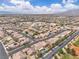 Expansive aerial view of a desert community featuring single-Gathering homes, streets, and scenic mountain views at 4624 Ventana Rey St, North Las Vegas, NV 89081