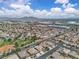 Community aerial featuring numerous homes, landscaping, and a grassy area with desert mountain views at 4624 Ventana Rey St, North Las Vegas, NV 89081
