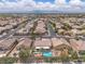Elevated view showcasing a home with a private pool, lush landscaping, and a well-planned community at 4624 Ventana Rey St, North Las Vegas, NV 89081