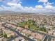 Picturesque aerial of a neighborhood with houses, a green community park, and mountain backdrop at 4624 Ventana Rey St, North Las Vegas, NV 89081