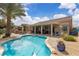 Beautiful backyard pool with a covered patio and outdoor seating area surrounded by desert landscaping at 4624 Ventana Rey St, North Las Vegas, NV 89081