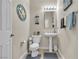 Cozy half-bathroom featuring a pedestal sink and coastal decor, perfect for guests at 4624 Ventana Rey St, North Las Vegas, NV 89081