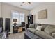 Bright bedroom with a sleeper sofa, dark wood shelving, and shuttered window at 4624 Ventana Rey St, North Las Vegas, NV 89081