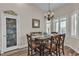 This dining room has wood-look floors, a dark wood table, and plantation shutters for privacy at 4624 Ventana Rey St, North Las Vegas, NV 89081