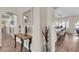 View of an entryway with wood-look floors and a decorative table leading into the eat-in kitchen at 4624 Ventana Rey St, North Las Vegas, NV 89081