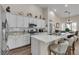 A spacious kitchen with a large island, stainless steel appliances, and a view into the dining area at 4624 Ventana Rey St, North Las Vegas, NV 89081