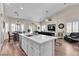 Bright, open kitchen overlooking the living and dining area features an island and modern appliances at 4624 Ventana Rey St, North Las Vegas, NV 89081
