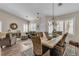 A open-concept living and dining area features wood floors, neutral walls, and bright natural light at 4624 Ventana Rey St, North Las Vegas, NV 89081