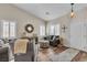 Bright living room with vaulted ceilings, wood floors, and stylish furnishings at 4624 Ventana Rey St, North Las Vegas, NV 89081