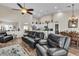 Bright open-concept living space featuring a ceiling fan, neutral tones, and an adjacent dining and kitchen area at 4624 Ventana Rey St, North Las Vegas, NV 89081