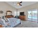 Vaulted main bedroom with access to the backyard pool area, ceiling fan, and two dressers at 4624 Ventana Rey St, North Las Vegas, NV 89081