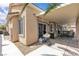 Relaxing covered patio with plush seating, outdoor dining, and a convenient grilling area at 4624 Ventana Rey St, North Las Vegas, NV 89081