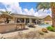 Spacious outdoor patio with a built-in grill, bar seating, and comfortable dining area by the pool at 4624 Ventana Rey St, North Las Vegas, NV 89081