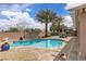 Refreshing backyard pool featuring brick trim, swaying palms, and relaxing lounge area at 4624 Ventana Rey St, North Las Vegas, NV 89081
