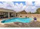 Inviting pool area with a uniquely shaped pool, brick trim, and lush landscaping at 4624 Ventana Rey St, North Las Vegas, NV 89081