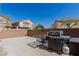 Backyard patio with outdoor grill and desert landscaping and brick perimeter wall at 4808 Straight Flush Dr # 103, Las Vegas, NV 89122