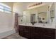 Bathroom featuring double vanity, large mirror, a tub-shower, and natural light at 4808 Straight Flush Dr # 103, Las Vegas, NV 89122