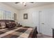 Bedroom with a bed and closet doors, complemented by ample natural light from the window at 4808 Straight Flush Dr # 103, Las Vegas, NV 89122
