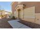 Home's front entry with decorative door, walkway, desert landscaping, and visible house number at 4808 Straight Flush Dr # 103, Las Vegas, NV 89122