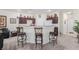 Kitchen featuring bar-style seating and dark wooden cabinets at 4808 Straight Flush Dr # 103, Las Vegas, NV 89122