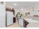 Kitchen with white appliances, dark wood cabinets, and view of the adjacent dining area at 4808 Straight Flush Dr # 103, Las Vegas, NV 89122