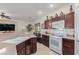 Bright kitchen with a gas range and white appliances, seamlessly connected to the living area at 4808 Straight Flush Dr # 103, Las Vegas, NV 89122