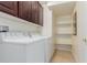 Bright laundry room with white washer and dryer, built-in cabinets, and convenient shelving at 4808 Straight Flush Dr # 103, Las Vegas, NV 89122