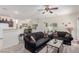 Living room with comfortable couches, ceiling fan, and view into the dining area at 4808 Straight Flush Dr # 103, Las Vegas, NV 89122