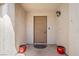 Inviting entryway features a neutral door flanked by red potted plants at 5224 Red Vine St, North Las Vegas, NV 89031