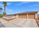 Single-story home featuring a large driveway, two-car garage, and desert landscaping at 5224 Red Vine St, North Las Vegas, NV 89031