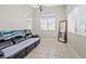 Bright living room with tile flooring, large windows, and comfortable seating at 5224 Red Vine St, North Las Vegas, NV 89031