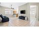 Open-concept living room with tile flooring, ceiling fan, and seamless kitchen view at 5224 Red Vine St, North Las Vegas, NV 89031