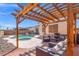 The outdoor seating area features a pergola and leads to the pool and hot tub for easy access and relaxation at 5224 Red Vine St, North Las Vegas, NV 89031