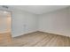 Bedroom featuring sleek wood-look floors and a bright neutral color palette at 5409 Holmby Ave, Las Vegas, NV 89146