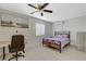 Cozy bedroom with desk, ceiling fan, and neutral colors, offering comfortable living at 5409 Holmby Ave, Las Vegas, NV 89146