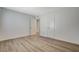 Bedroom featuring modern wood-look floors, white trim, and neutral walls at 5409 Holmby Ave, Las Vegas, NV 89146