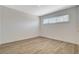 Well-lit bedroom featuring a window and wood-look flooring at 5409 Holmby Ave, Las Vegas, NV 89146