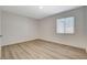 Bright bedroom featuring wood-look floors and a window with coverings at 5409 Holmby Ave, Las Vegas, NV 89146