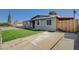 Quaint single-story home with a spacious driveway and chain-link fenced yard at 5409 Holmby Ave, Las Vegas, NV 89146