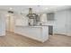 Modern kitchen featuring gray cabinets, stainless steel appliances, and a large island with a white countertop at 5409 Holmby Ave, Las Vegas, NV 89146