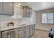 Modern kitchen features gray cabinets, stainless steel appliances, and a bright, clean design at 5409 Holmby Ave, Las Vegas, NV 89146