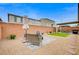 Backyard with a seating area, gravel, and small patch of artificial turf at 5479 Tamar Ridge Ct, Las Vegas, NV 89141
