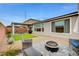 Backyard patio features a fire pit, seating, and grill under a covered area, perfect for entertaining at 5479 Tamar Ridge Ct, Las Vegas, NV 89141