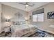 Comfortable bedroom with a ceiling fan, modern decor, and a cozy rug at 5479 Tamar Ridge Ct, Las Vegas, NV 89141